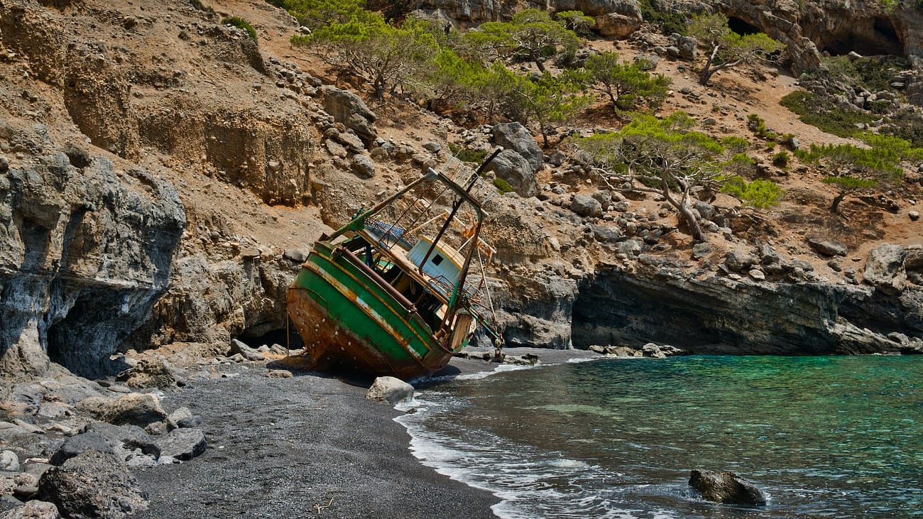 wreck fishing boat at the seashore